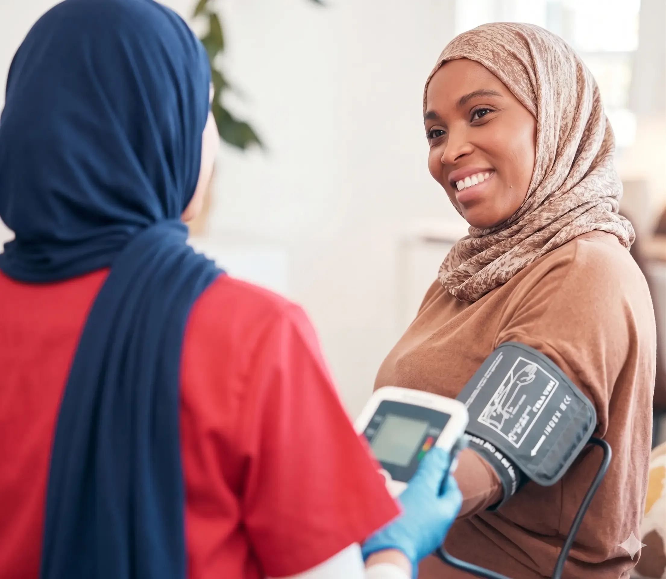 Nurse checking a patient's blood pressure during a doctor on call visit in Riyadh