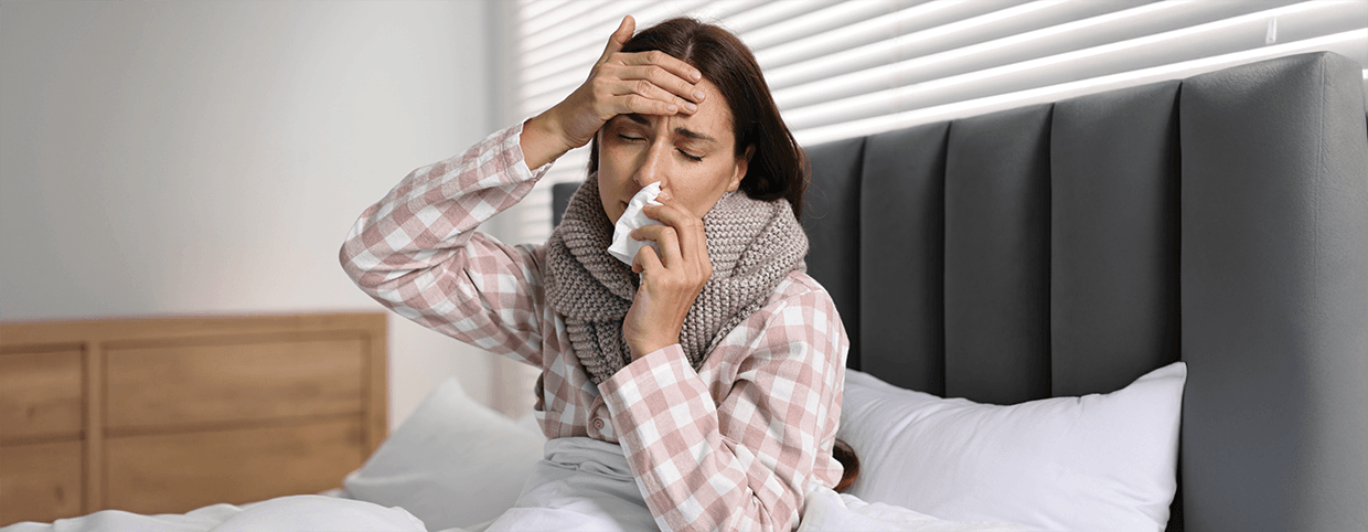 Woman experiencing flu symptoms