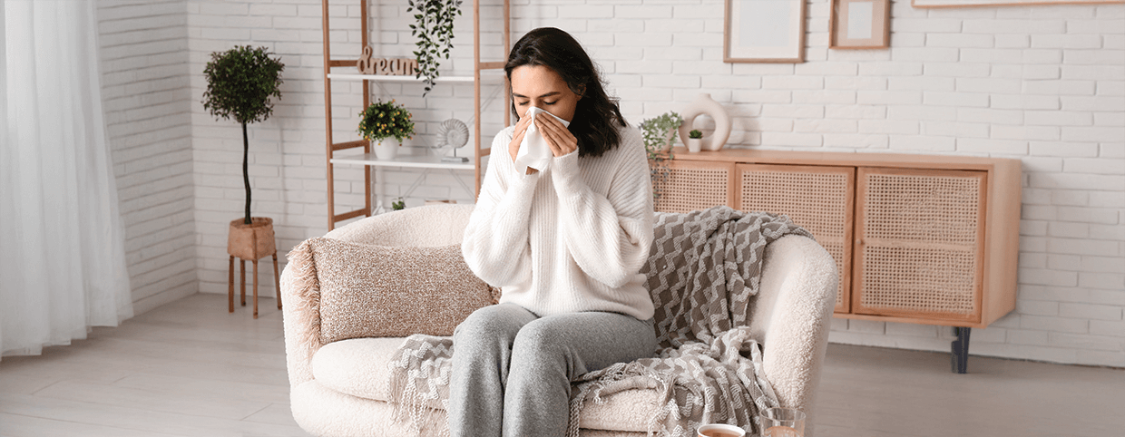 Woman sneezing due to the flu