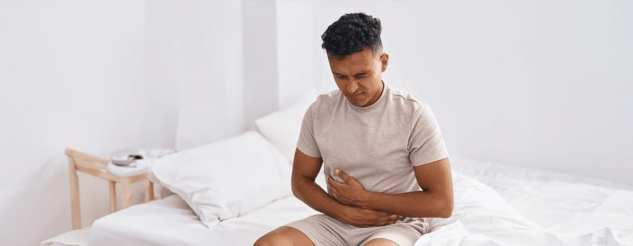 Man touching his belly and having a stomach ache