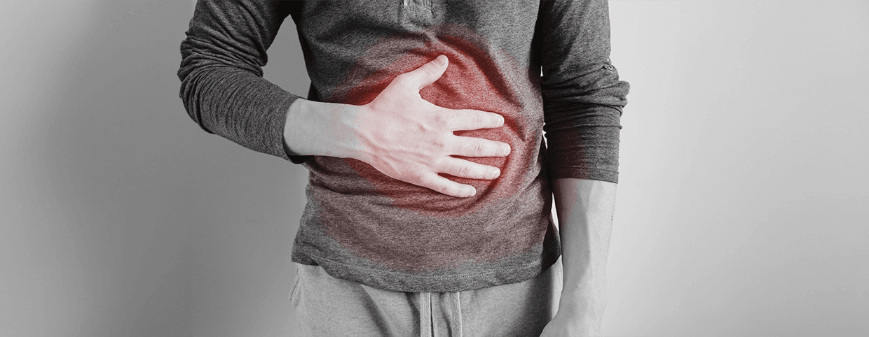  Man holding stomach due to stomach pain