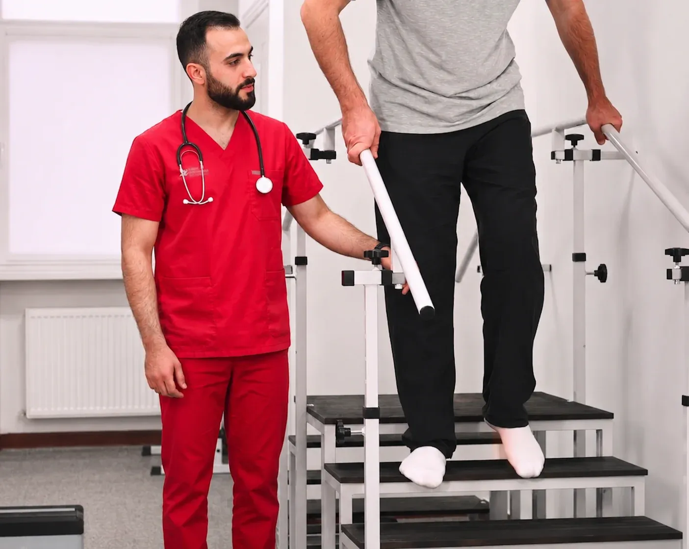 Physiotherapist supervising patient practicing stair walking with parallel bars