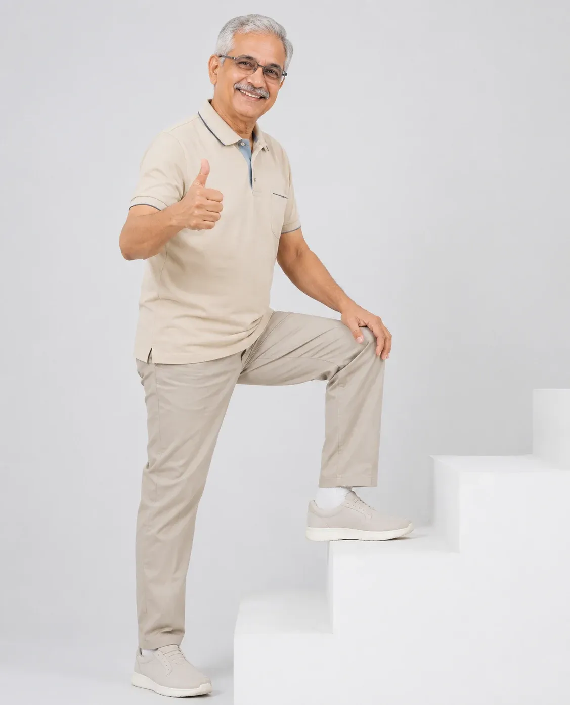 Senior man climbing stairs with confidence after physiotherapy for knee pain in Dubai