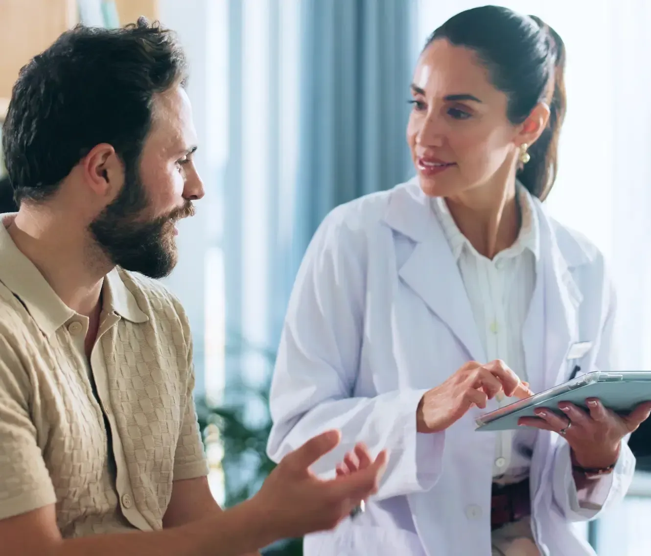 Doctor explaining full body health checkup results to a male patient in Dubai